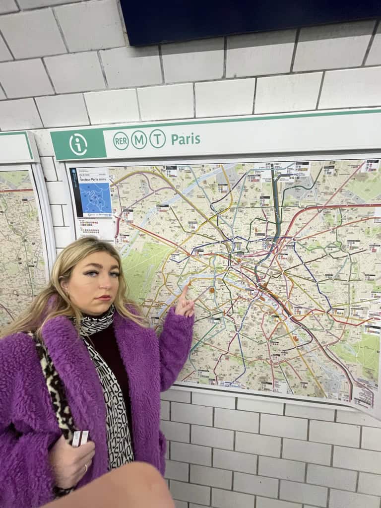 Charlie stood by map of the subway in Paris